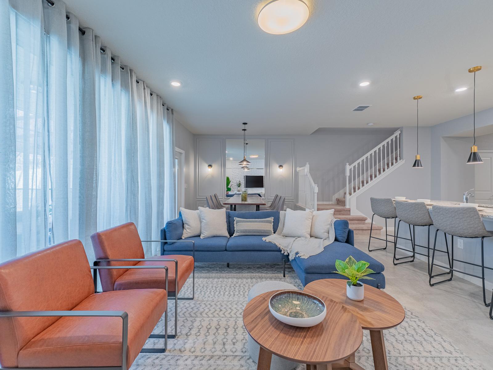 The living area, conveniently positioned near the kitchen counter bar table, fosters a seamless connection between relaxation and culinary delights.