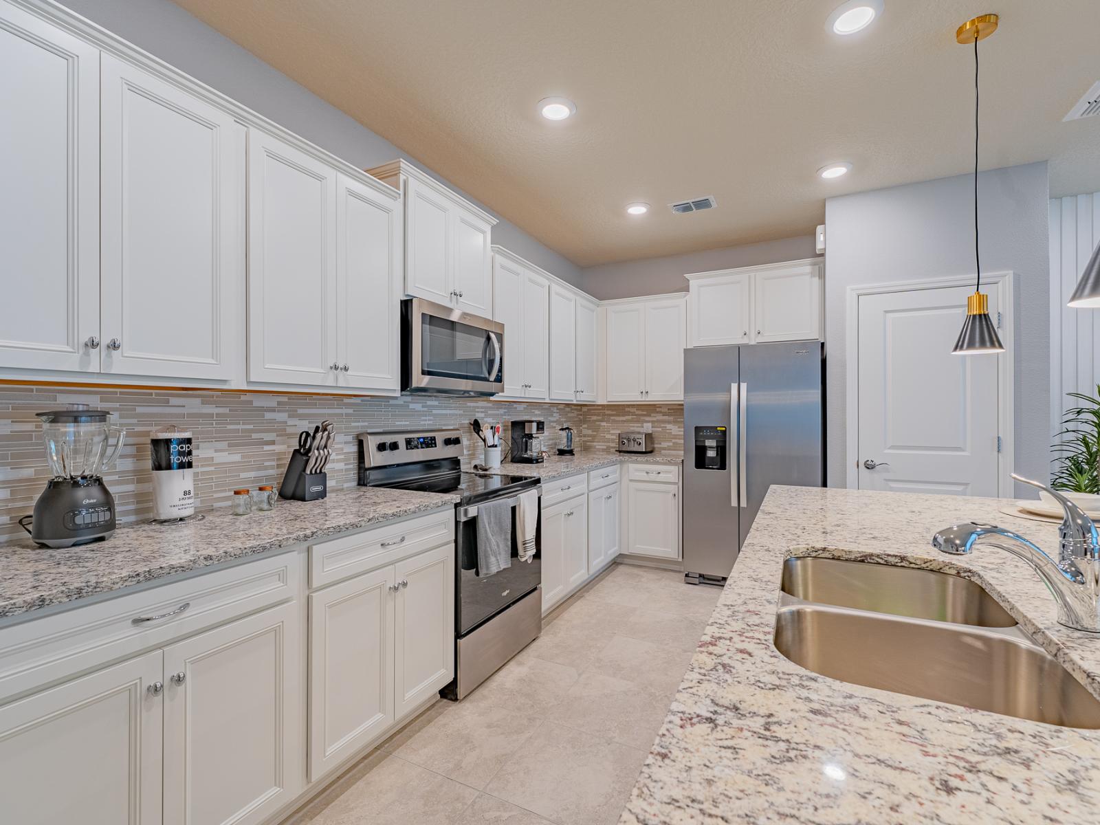 Contemporary Kitchen of the home in Davenport, Florida - Plenty of storage options guarantee impeccably tidy counters - Cutting-edge, stainless steel appliances adorn this ultra-modern culinary space