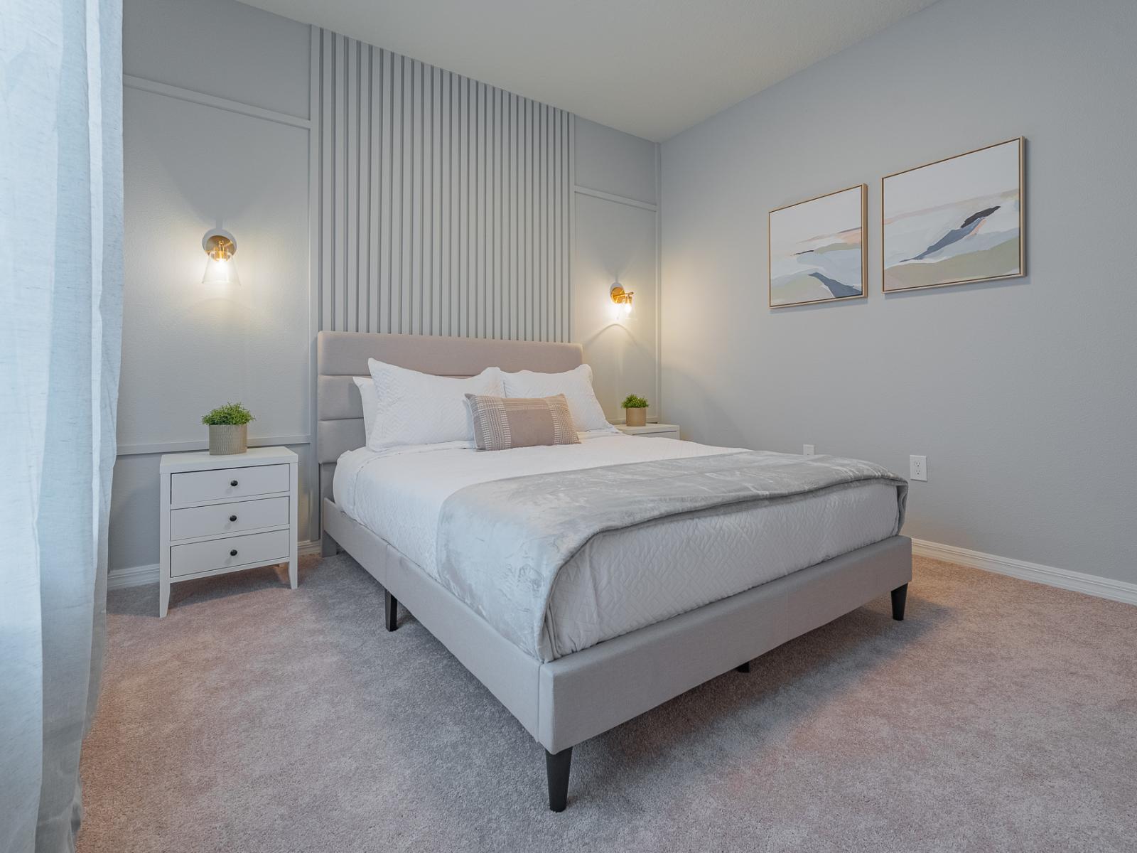 This bedroom captivates with its accent wall and lovely side table lamps, creating an ambiance of timeless elegance. A sanctuary where every detail is curated for comfort and style, promising serene