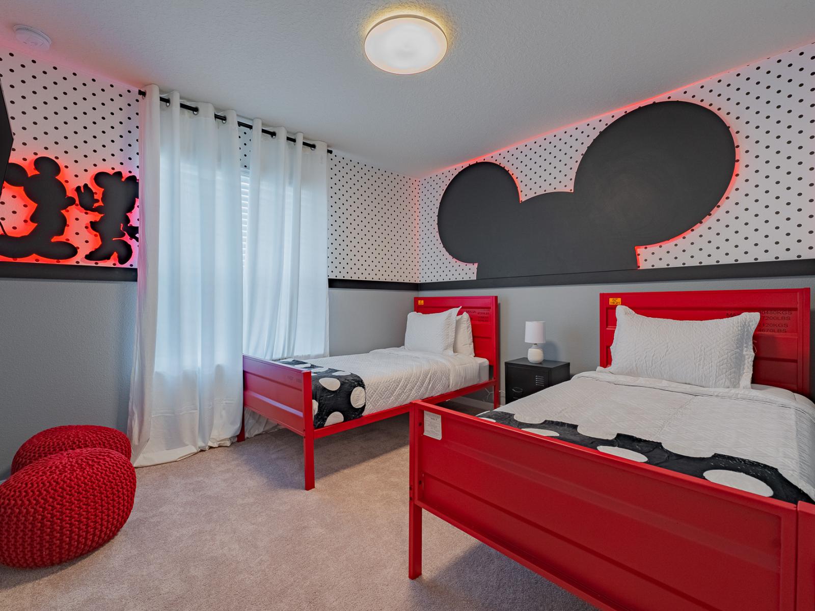 Mickey and Minnie Mouse inspired bedroom  of the home in Davenport, Florida - Magic of Disney comes to life. With two beds adorned in playful motifs - Bright and airy bedroom bathed in sunlight from large windows - Smart TV for kids entertainment