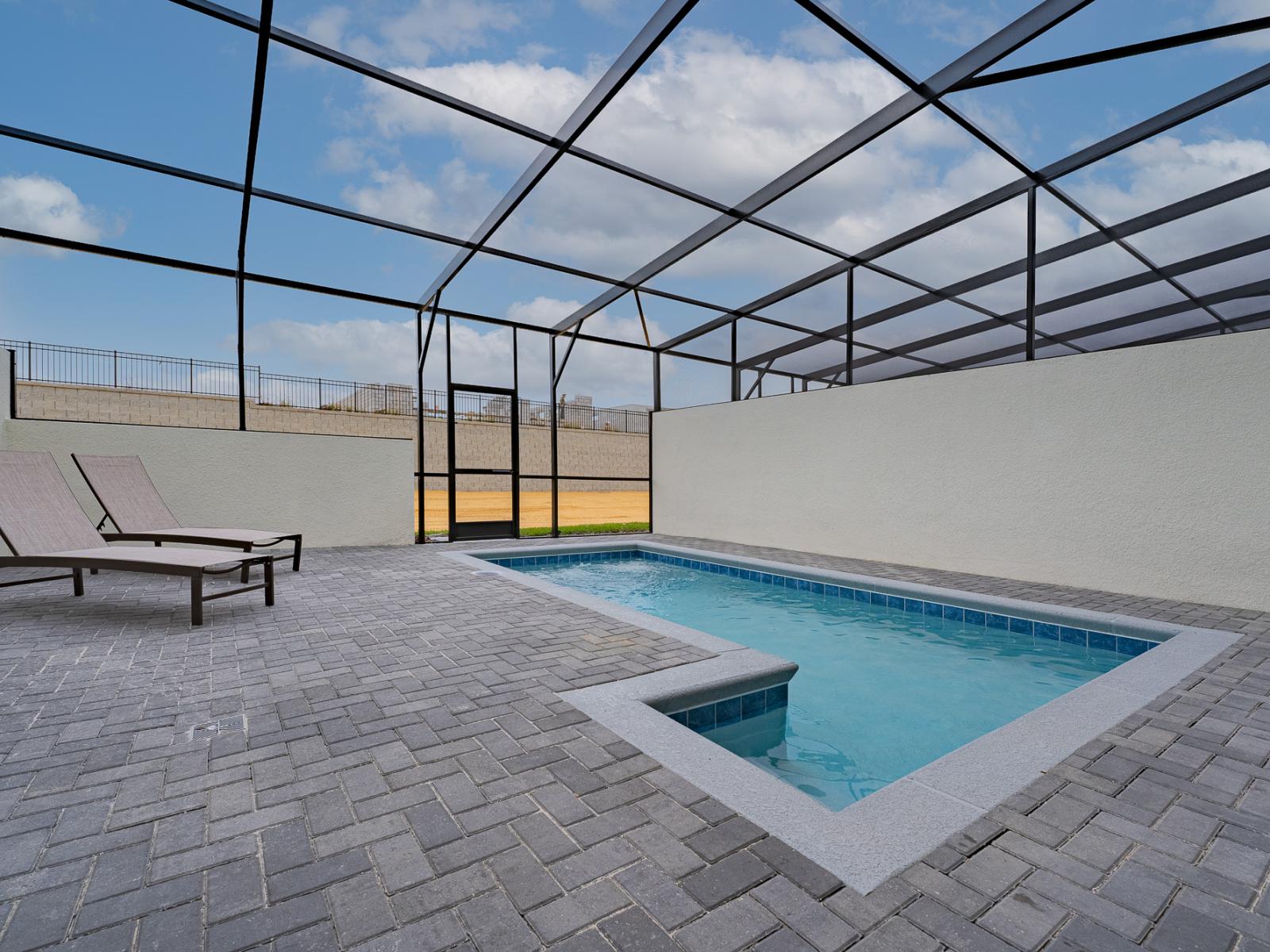 Breathtaking private pool of the home in Davenport, Florida - Enjoy unrivaled privacy as you swim under the stars in your private glass-covered pool - Chill out, decompress, and bask in the sun with panache