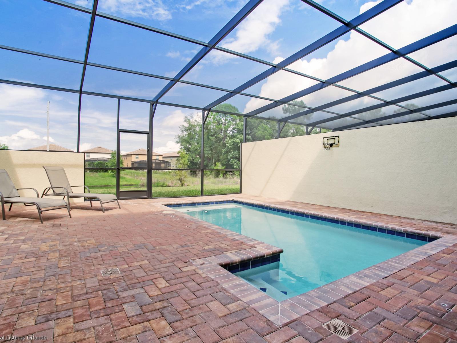 Private pool of the townhouse in Kissimmee, Florida - Unparalleled privacy as you swim beneath the stars in your exclusive glass-covered pool - Relax, unwind, and soak up the sun in style