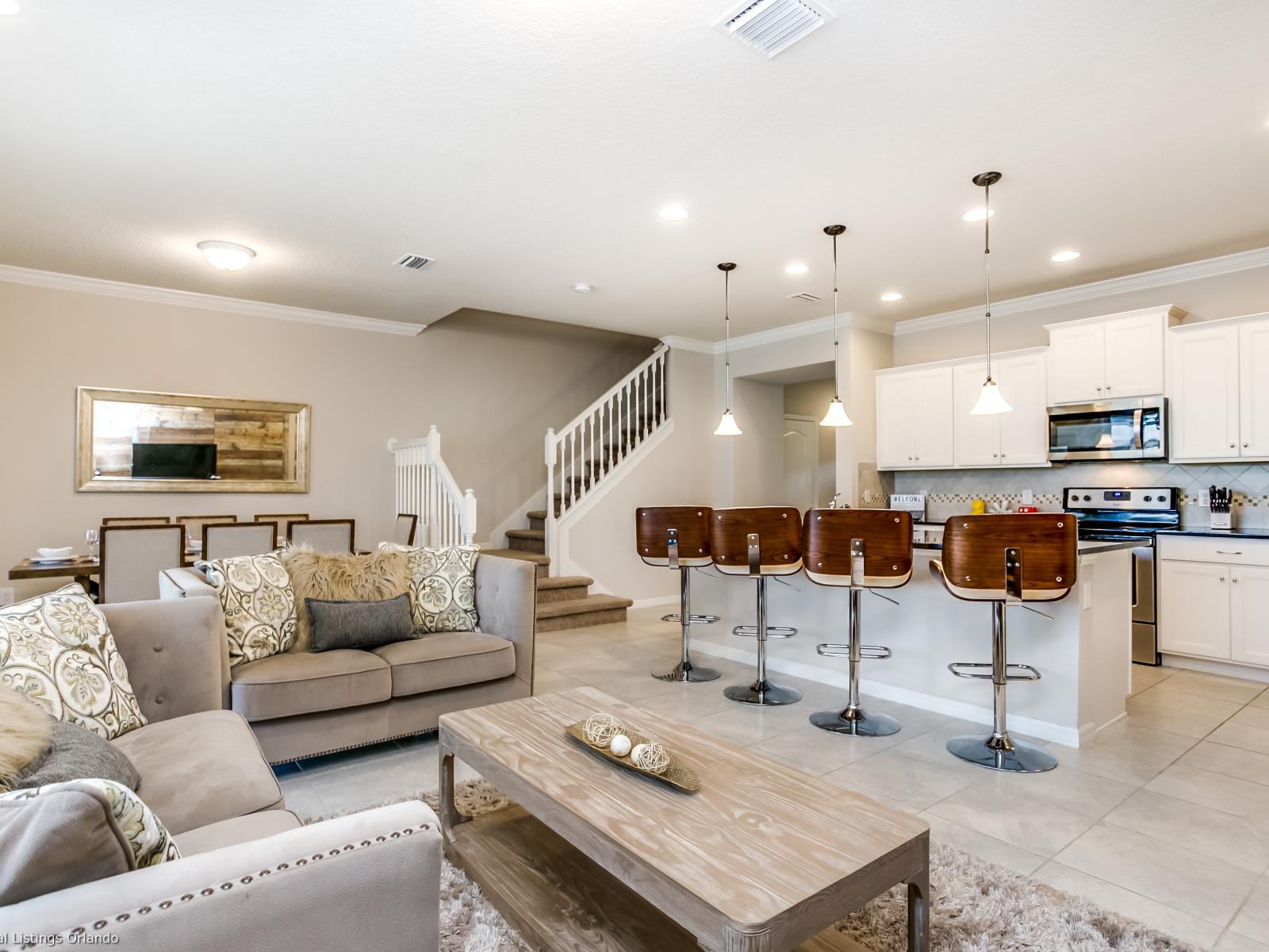 Stunning living area of the townhouse in Kissimmee, Florida - Comfortable seating with open kitchen and breakfast bar -  living room provides an ideal setting to come together and exchange stories