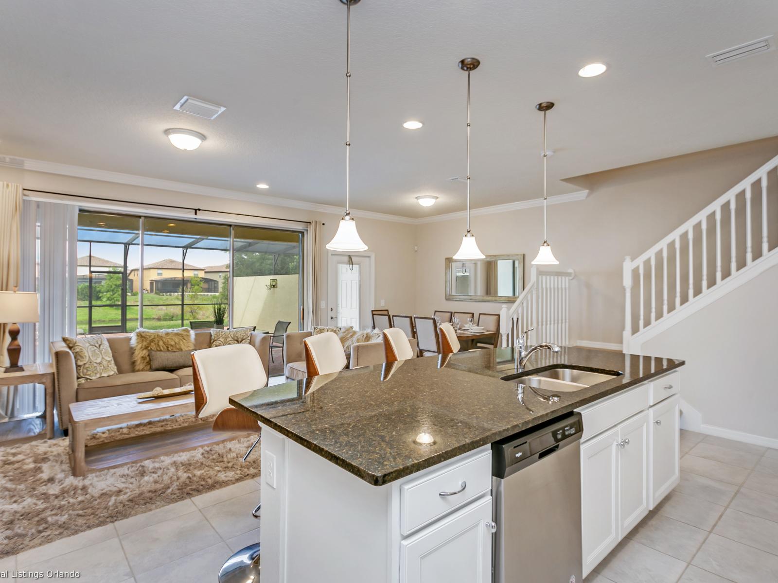 The kitchen, living, and dining areas merge seamlessly, creating a vibrant hub where cooking, relaxation, and dining converge, fostering a sense of togetherness and comfort.