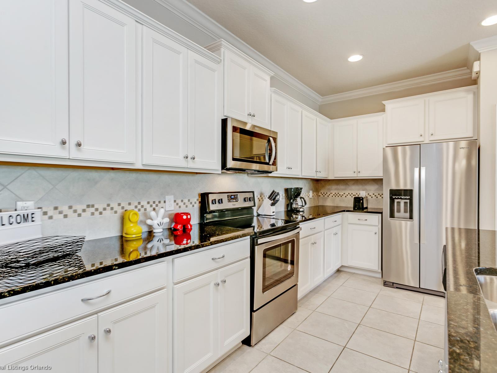 Lush kitchen of the townhouse in Kissimmee, Florida  - Sleek and modern kitchen space with stainless steel appliances - Thoughtful placement of kitchen essentials for easy access