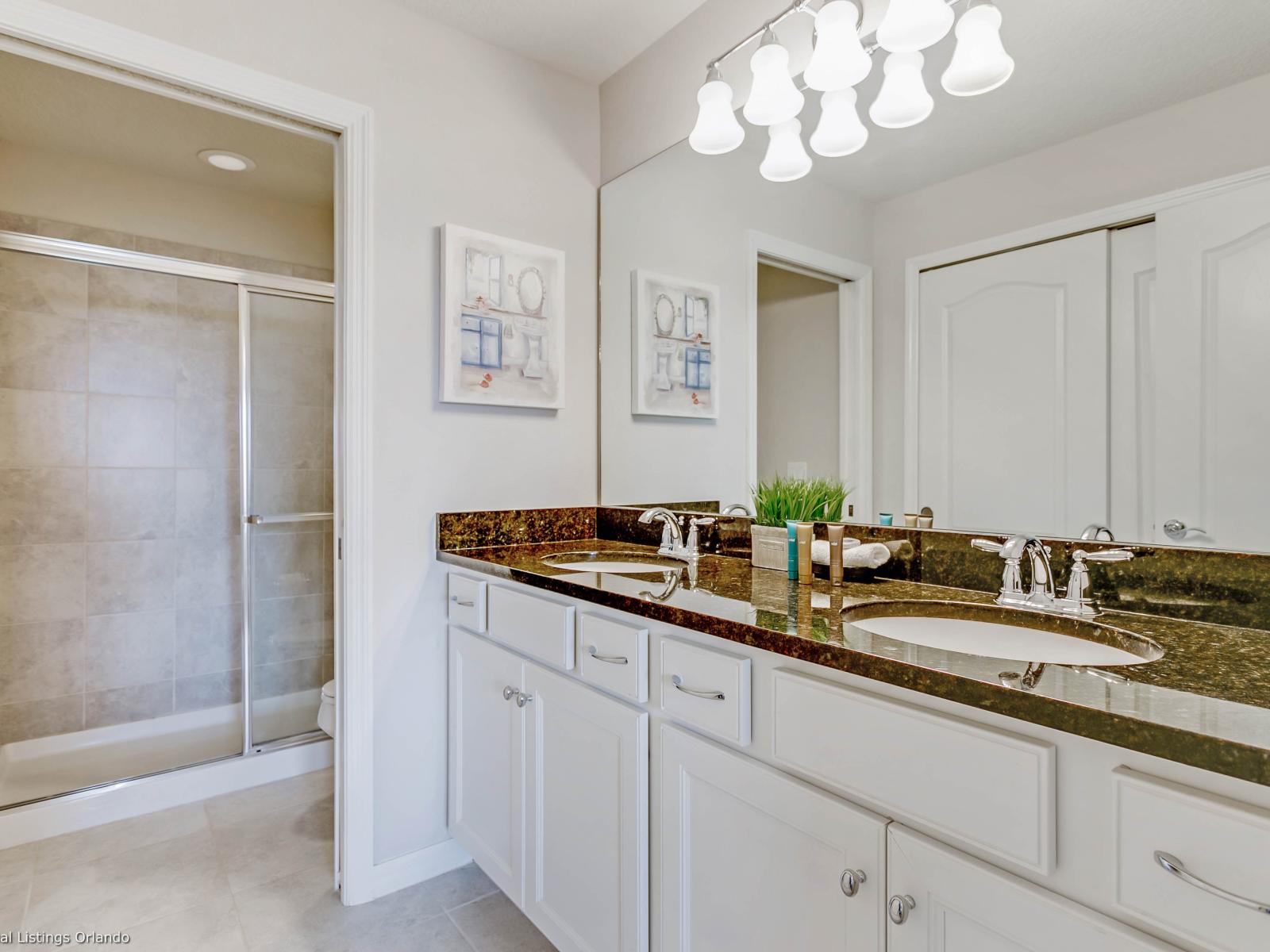 Stylish bathroom of the townhouse in Kissimmee, Florida  - Sanctuary of luxury and relaxation, where elegant design meets comfort - Experience pristine hygiene with our spotless bathroom - Elegant pendant lights for a touch of glamour