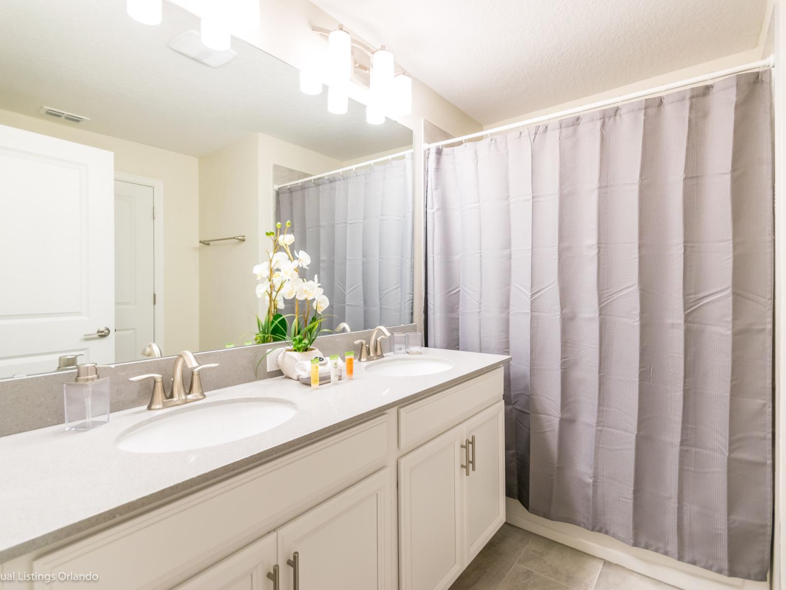 Bathroom 2 with double vanity and tub/shower combination