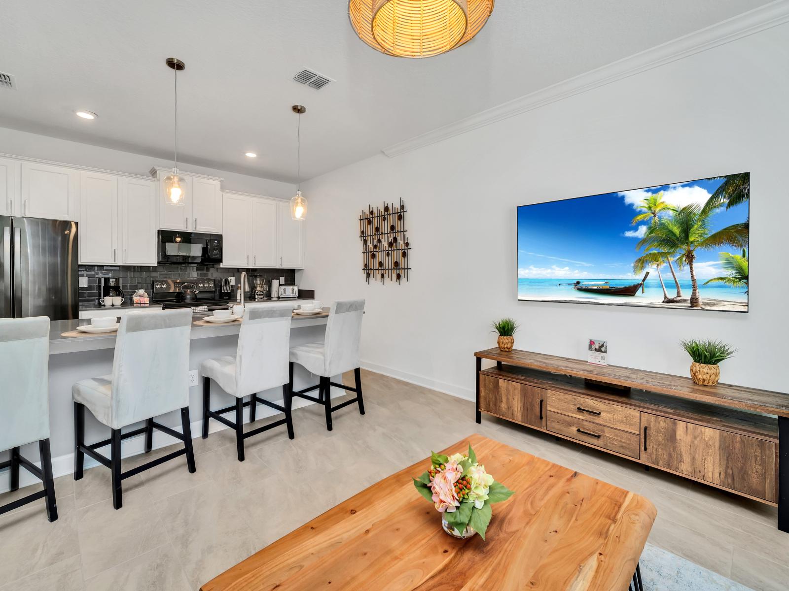 the strategic placement where guests can catch up on their favorite shows or movies while cooking, dining, or relaxing in the living space, enhancing their overall experience and convenience.