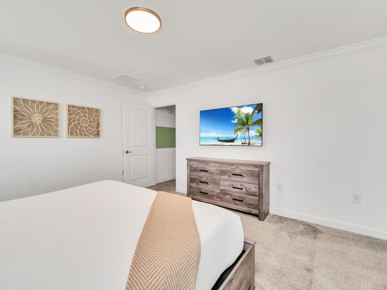 The bedroom  is an oasis of entertainment and relaxation. With its comfortable furnishings and modern amenities, guests can unwind and enjoy their favorite shows or movies in the privacy and comfort of their own room