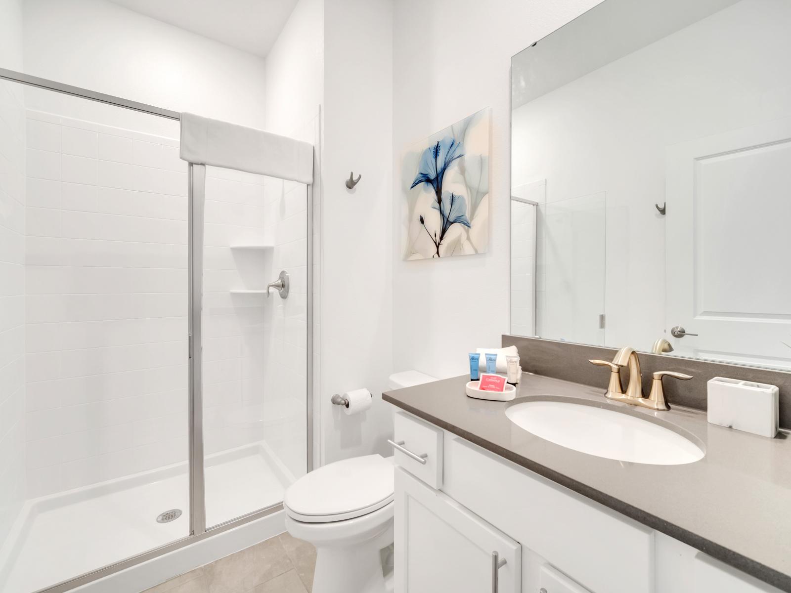 The bathroom  is a modern retreat designed for comfort and relaxation. With contemporary fixtures, sleek finishes, and thoughtful amenities, it offers guests a serene space to refresh and rejuvenate during their stay.