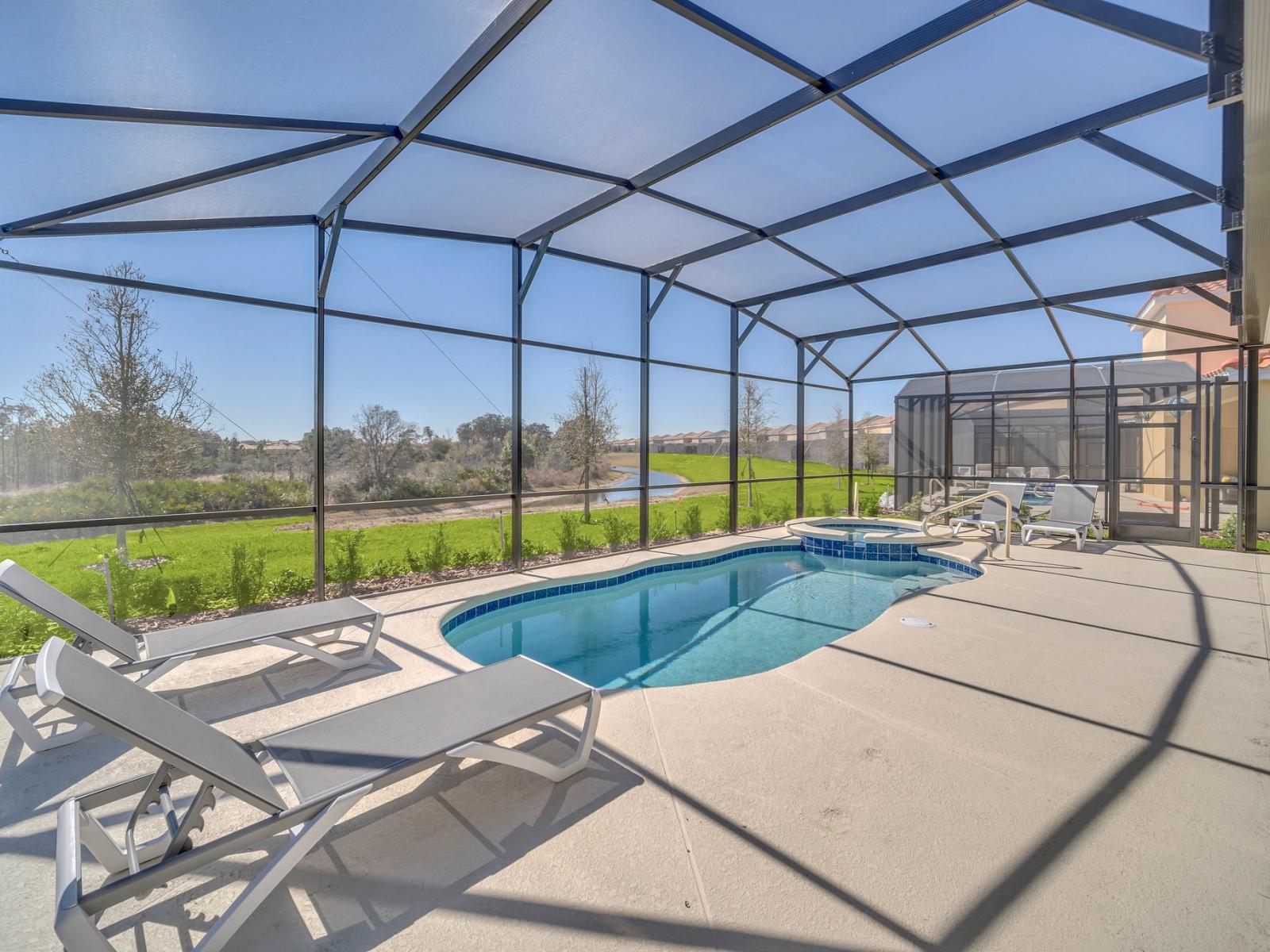 Experience the inviting atmosphere of the private screened-in lanai, perfect for entertaining and relaxation, complete with comfortable patio furniture, a luxurious outdoor dining setup, poolside loungewear, and the convenience of spa and pool.