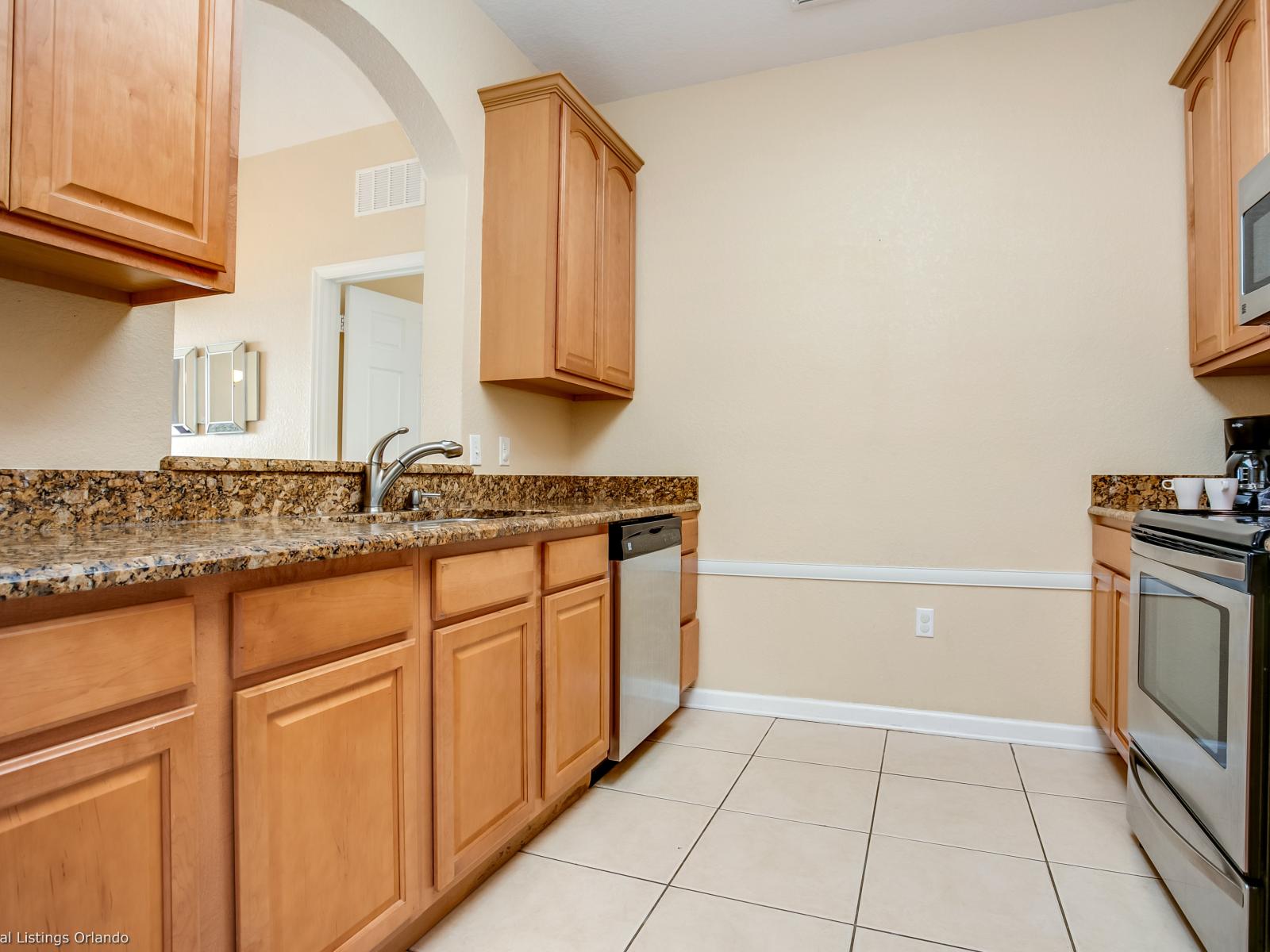 Kitchen- With sleek white cabinets complemented by gray accents, it offers a stylish and sophisticated space for culinary creativity and entertaining, blending modern design with timeless appeal.