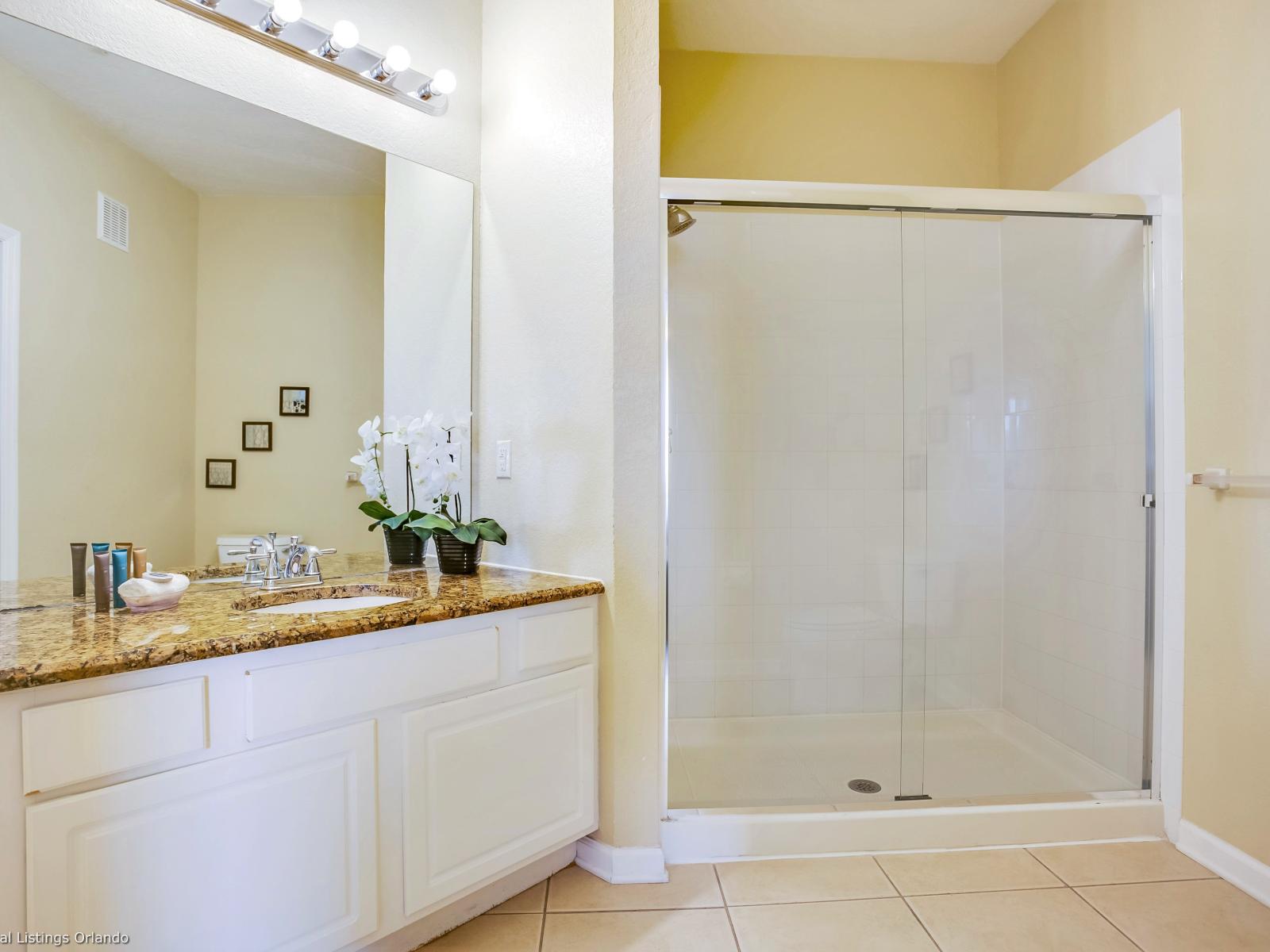 This toilet and bath, featuring a sleek shower enclosure, offers a refreshing retreat where modern design meets functionality, providing a rejuvenating space to start and end the day.