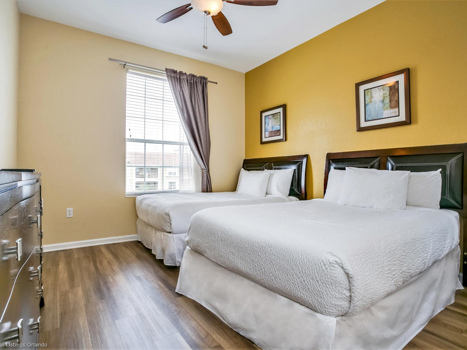 Dual comfort, twice the allure: Step into this spacious two-bed bedroom at Vista Cay Resort, where contemporary design meets relaxation, offering guests a stylish and restful retreat for a perfect night's sleep.