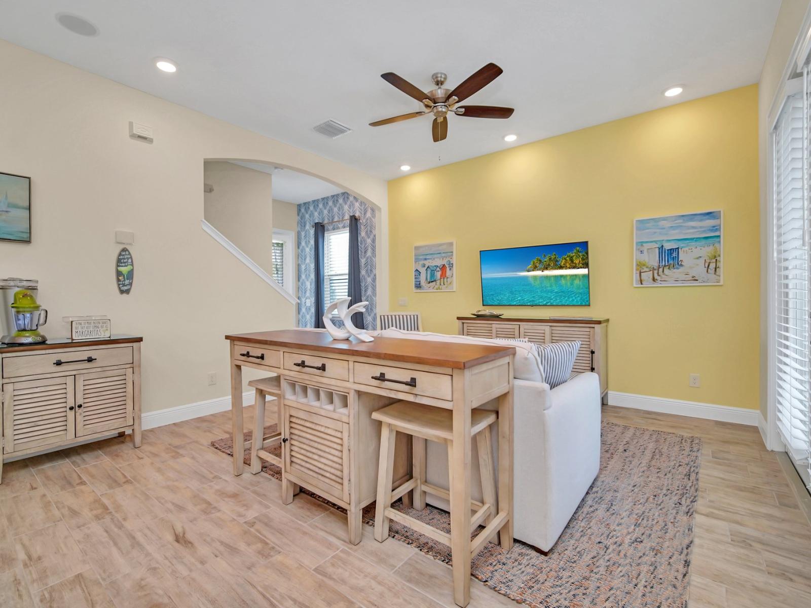 - Inviting living area of the cottage in Reunion Florida - Cozy seating area conducive to relaxation and socializing - Smart TV and Netflix - Artfully arranged decor elements, from wall art to decorative accessories