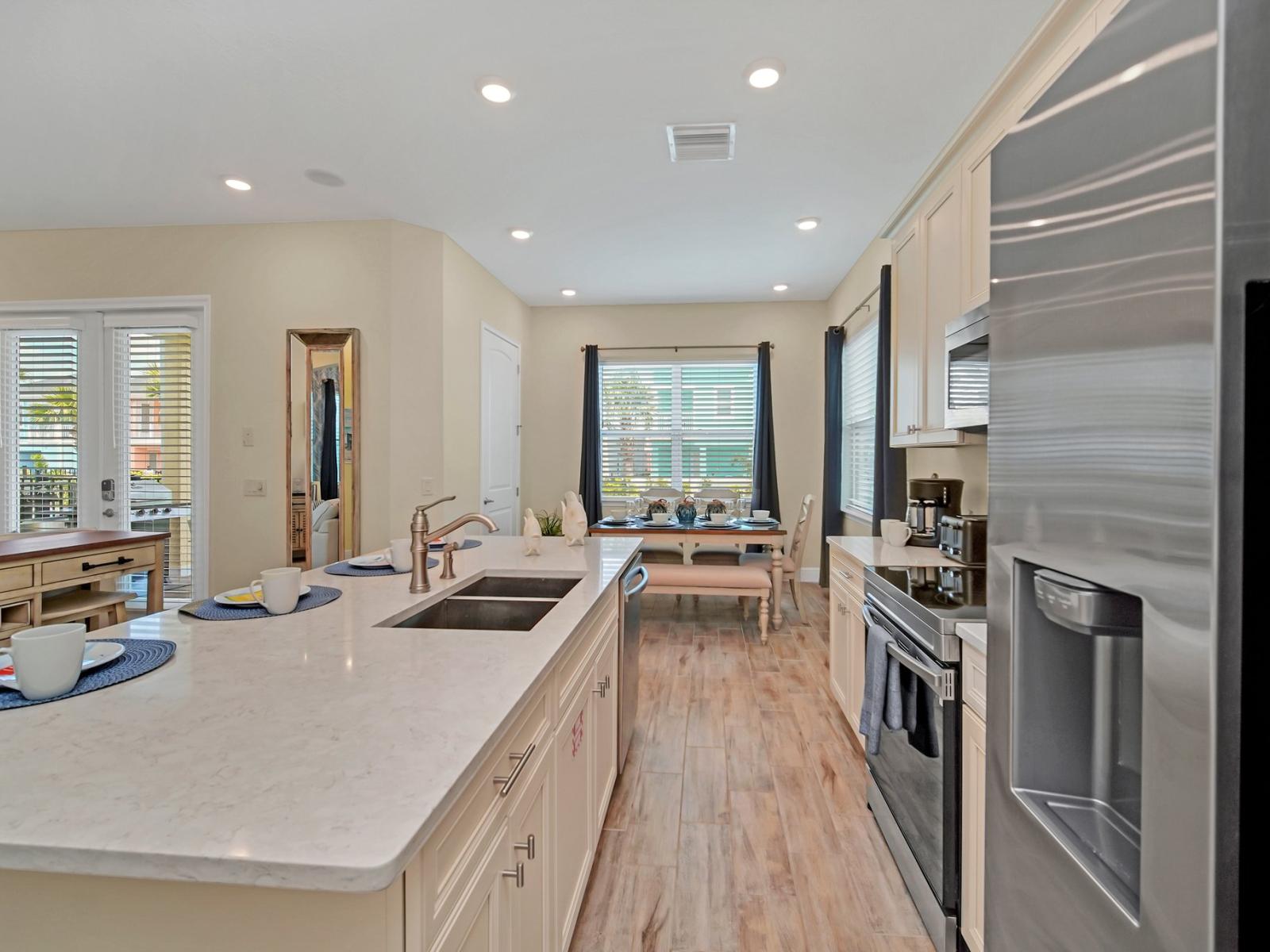 - Luxe kitchen of the cottage in Reunion Florida - Experience culinary excellence and warm hospitality in inviting kitchen - Harmonious blend of practicality and contemporary aesthetics - Thoughtful placement of kitchen essentials for easy access