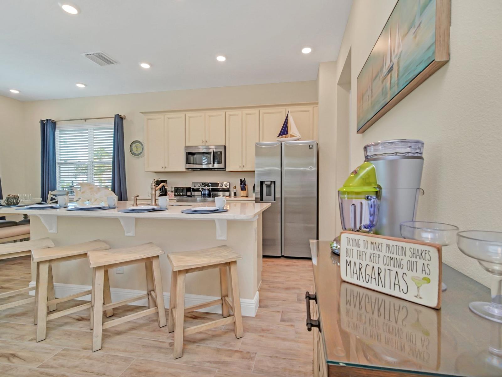 - Chic kitchen of the cottage in Reunion Florida - Breakfast bar for morning coffee or casual dining - Plenty of storage - Open concept connecting the kitchen to the dining and living area