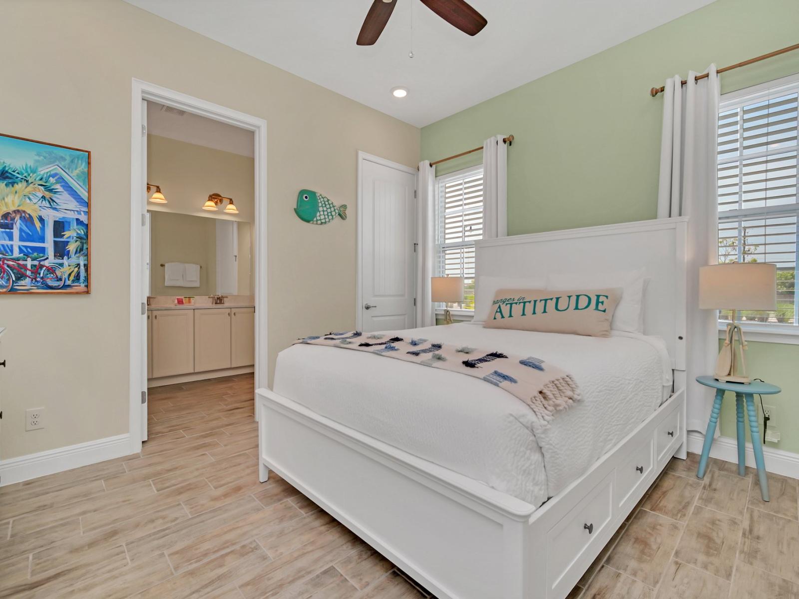 - Alluring bedroom of the cottage in Reunion Florida - Serene colors and thoughtful design come together to provide the perfect retreat - Cozy double bed - Stunning views from the bedroom window