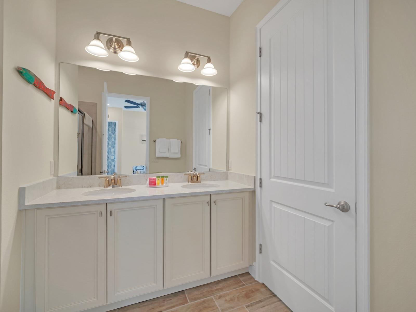 Luxurious Bathroom Retreat: Indulge in luxury and comfort in our spacious bathroom, featuring a vanity mirror, dual sinks, and a walk-in shower for a rejuvenating experience.