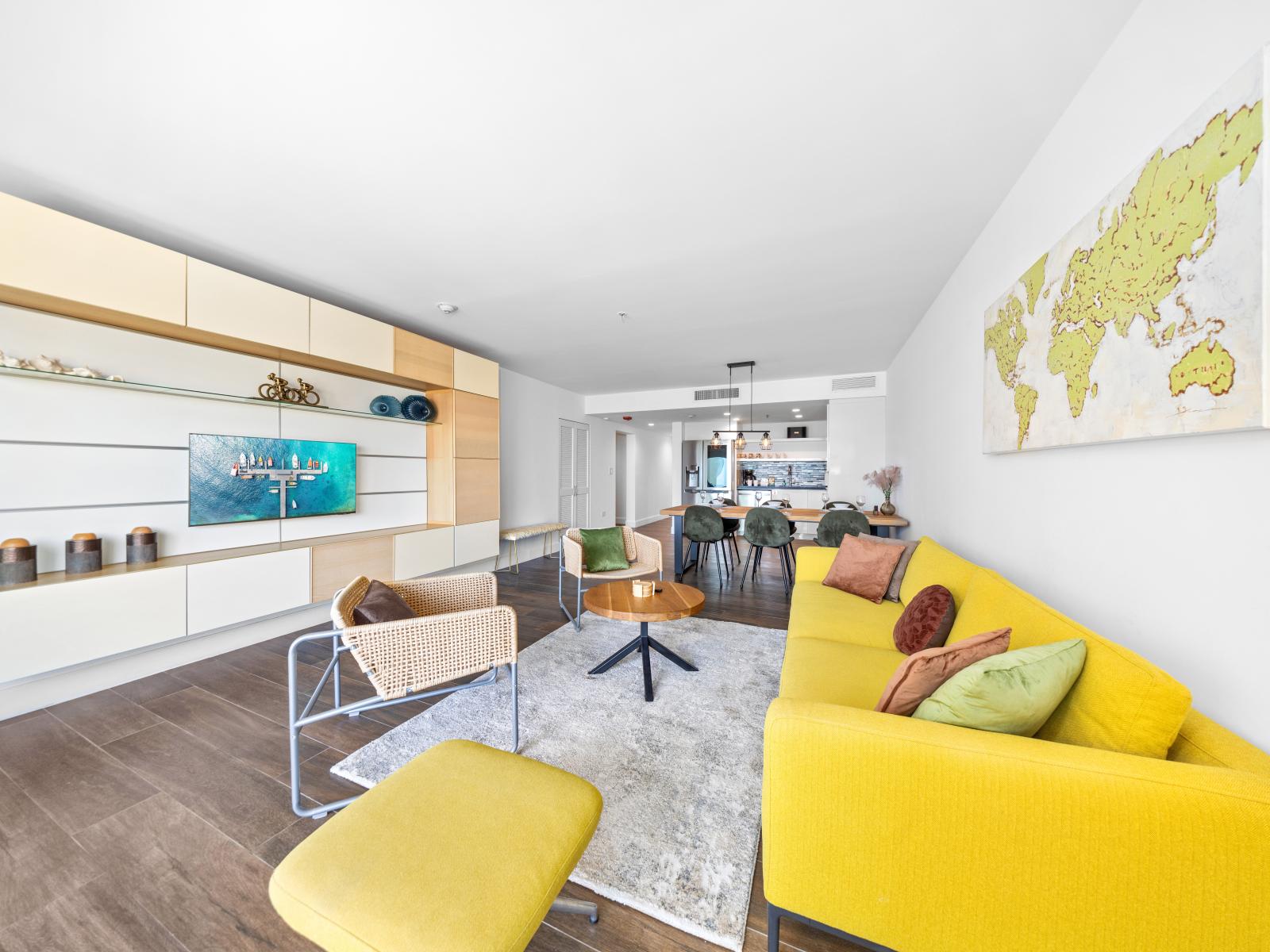 Posh Living Area of the condo in Aruba - Smart TV and Netflix - Stylish furniture arrangement providing comfort and a cohesive look - Private Balcony - Thoughtful mix of textures, from plush rugs to tasteful throw pillows - Hardwood Floor