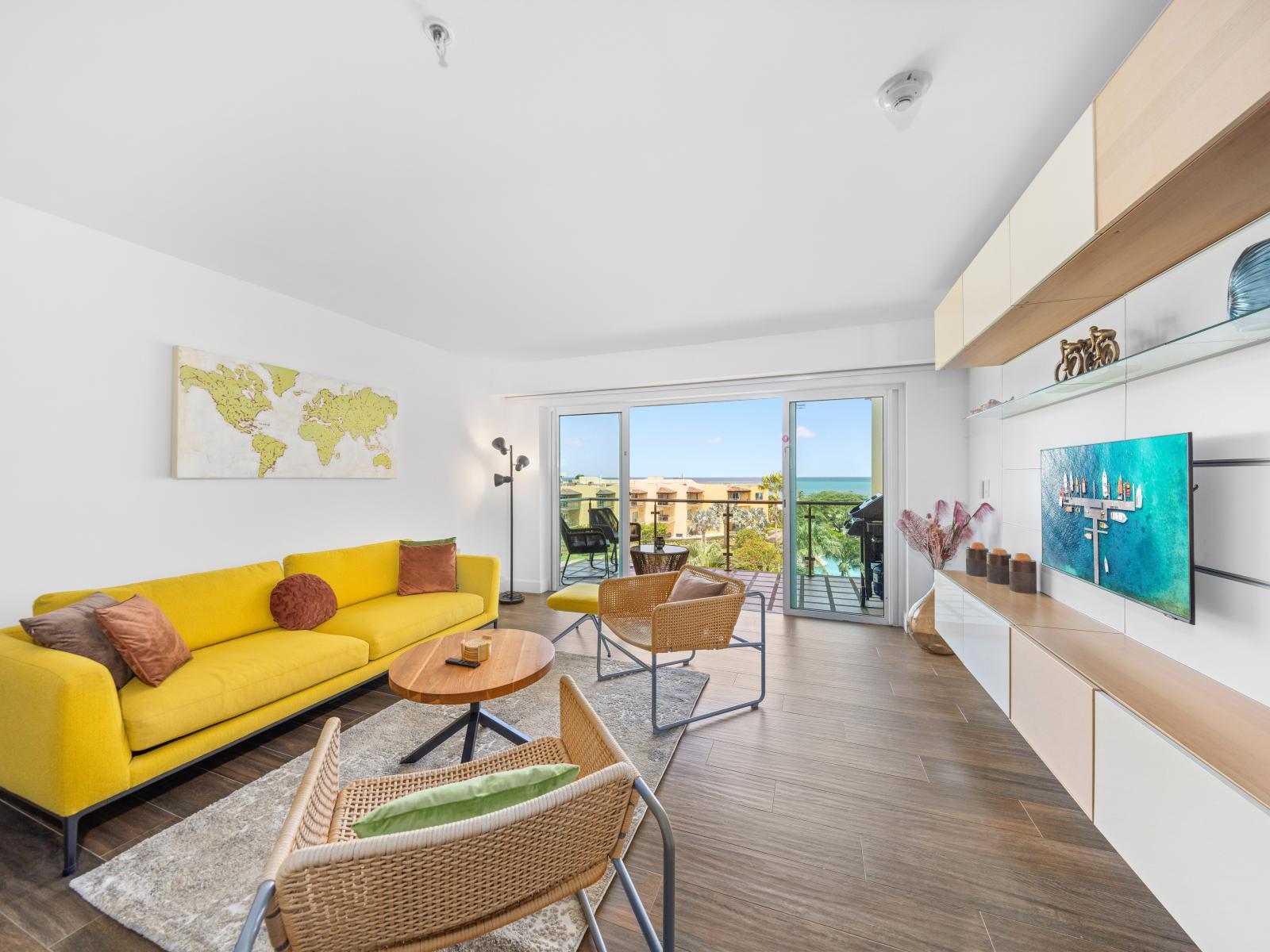 Outstanding Living of the condo in Aruba near Eagle Beach - Private Balcony - Open-concept living area seamlessly connected to a stylish dining space - Lush Ocean Views