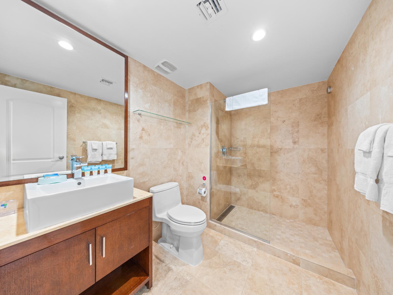 Step into relaxation in our main bathroom 2 with a spacious walk-in shower. Enjoy the perfect blend of elegance and convenience for your daily pampering