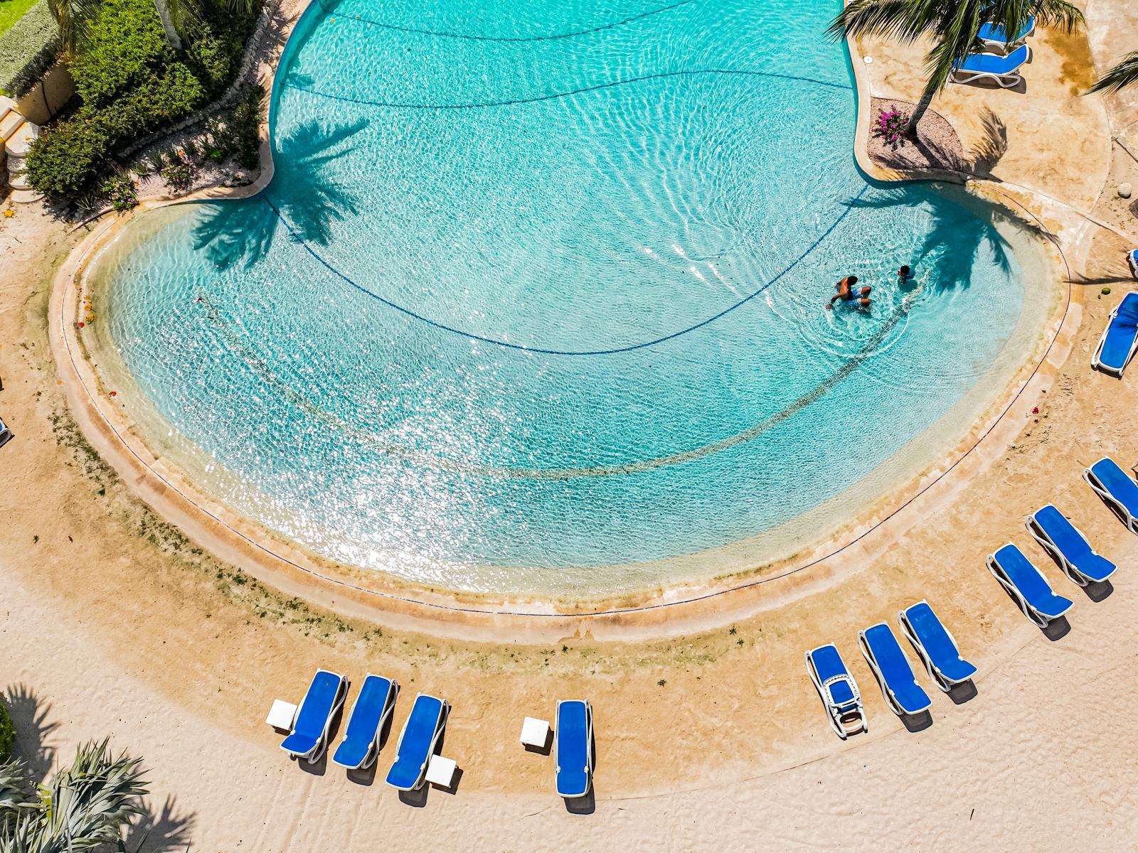 Enjoy our expansive shared pool, where you can wade into deeper waters gradually. Perfect for families and guests of all ages to swim and relax comfortably.