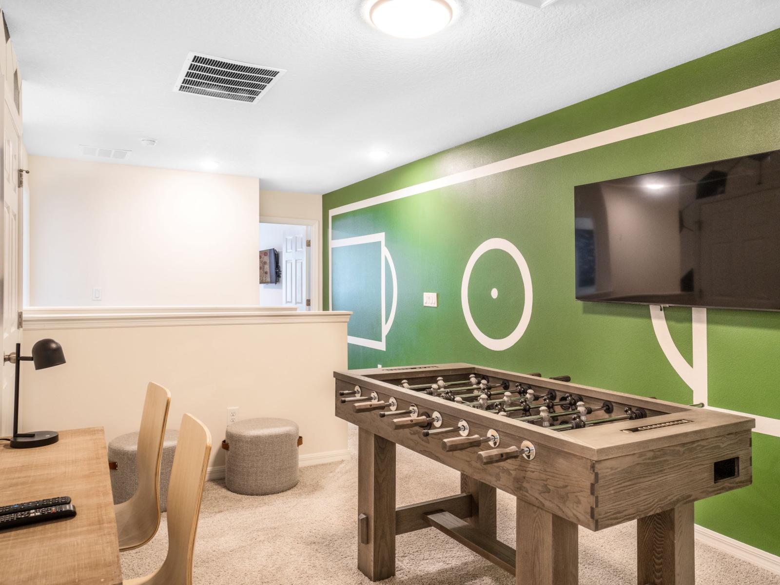 Sports-themed den of the townhouse in Four Corners Florida - A classic foosball table for exciting matches - Smart TV for added entertainment - Hours of enjoyment with a foosball table