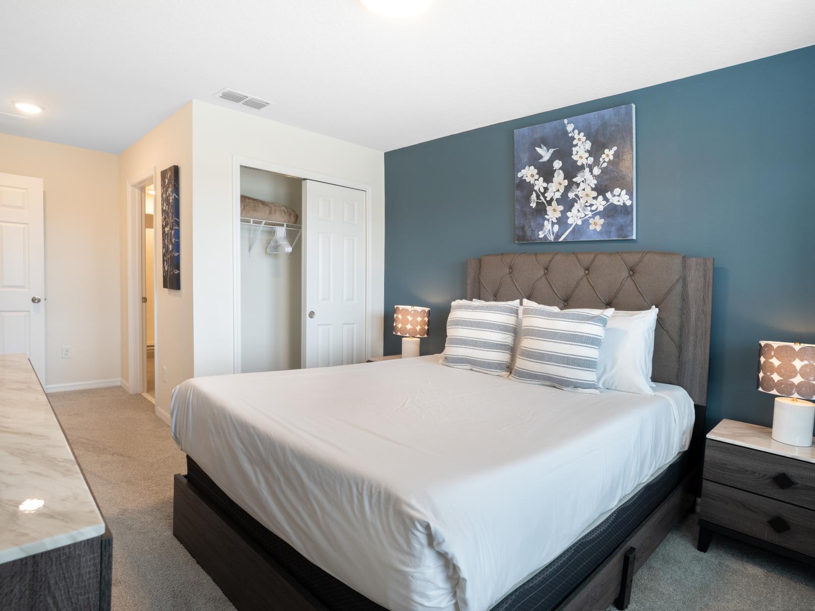 Stylish bedroom with elegant furnishings include a light marble top which contrast beautifully upon the dark turquoise walls.