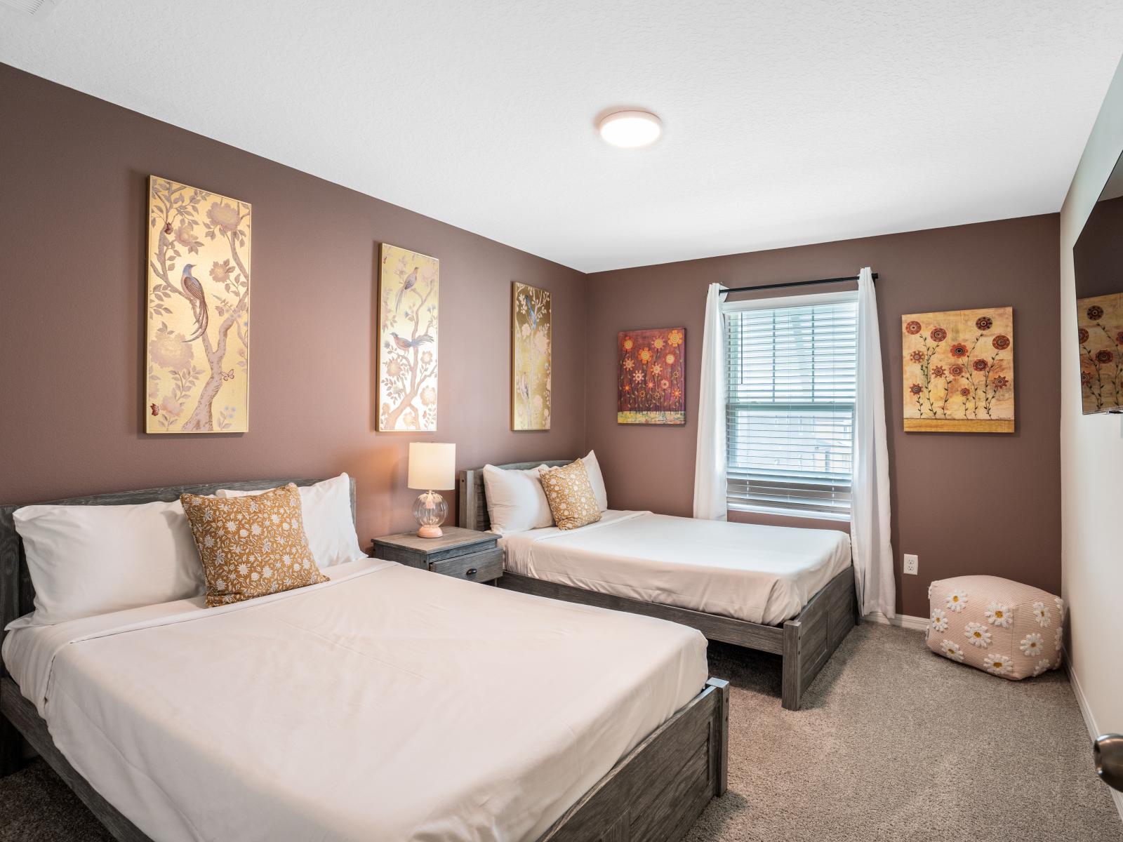 Elegant bedroom  of the townhouse in Four Corners Florida - Nature-inspired gold leafing artwork upon a tranquil mauve wall - Two cozy double bed - Harmonious color palette creating a soothing atmosphere