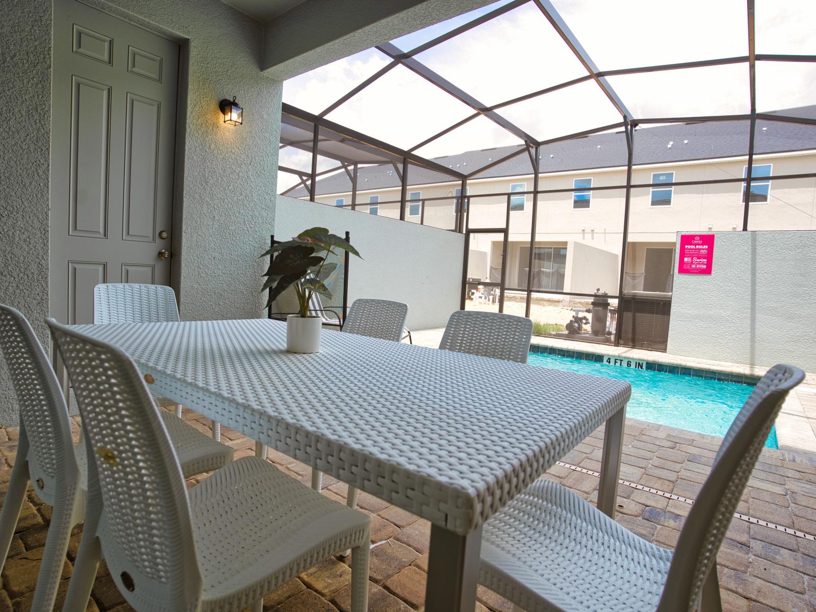 Lush outdoor dining area of the townhouse in Four Corners Florida - Savor the flavors of paradise with a side of poolside serenity - Outdoor dining experience offers a feast for the senses - Every meal accompanied by stunning pool views