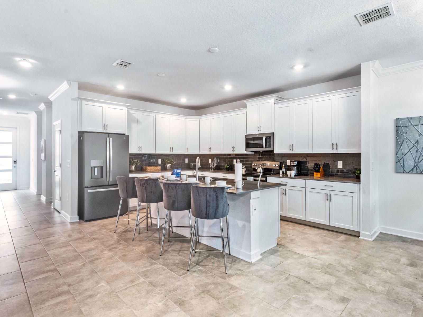 Modern kitchen of the Home in Davenport Florida - Fully-equipped  - Breakfast Bar and High Chairs - Plenty of Storage