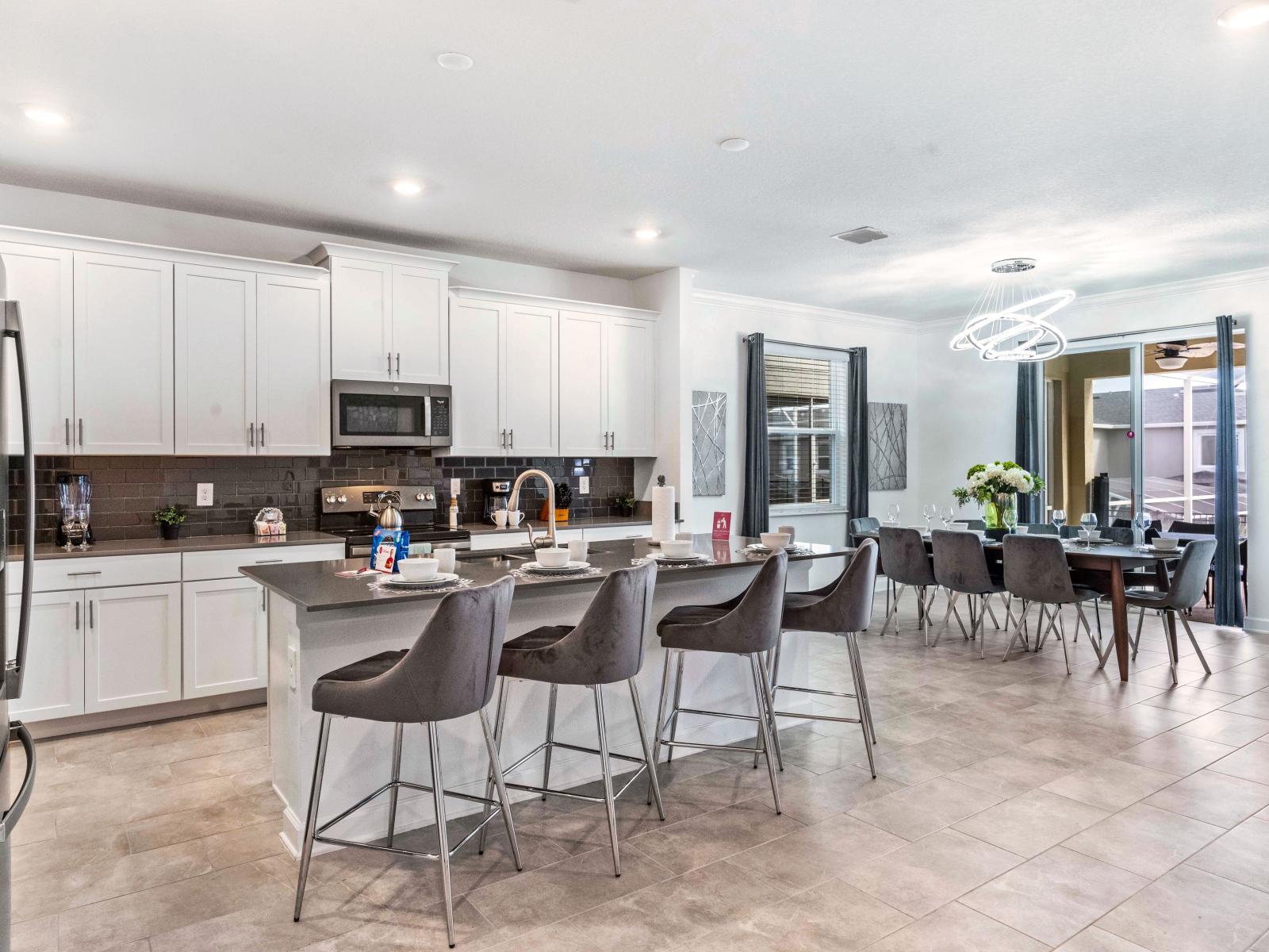 Stunning Home in Davenport Florida - The  modern kitchen and dining area beckon with inviting seating and stylish design - Gather, dine, and savor the moments in this perfect fusion of style and function - High Chairs