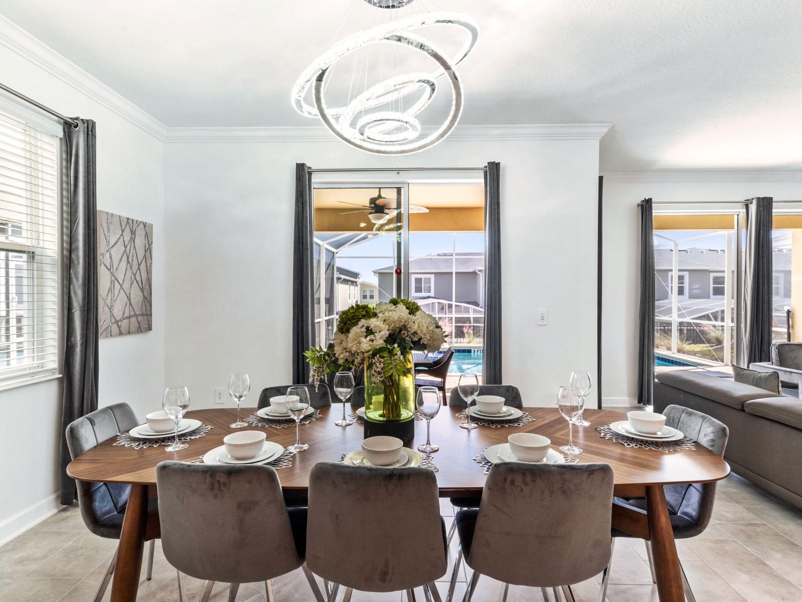 Fanciful Dining Area of the Home in Davenport Florida - Indulge in the art of dining on a grand scale at its dining area  - Meal becomes an event, and every gathering is a celebration of taste - Statement chandelier