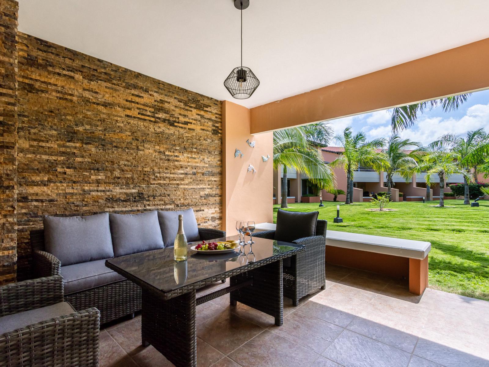 Lush Lounge area at private patio of the 3BR Condo in Oranjestad Aruba - Embrace a relaxed atmosphere in the great outdoors - A place to relax and socialize - Amazing views