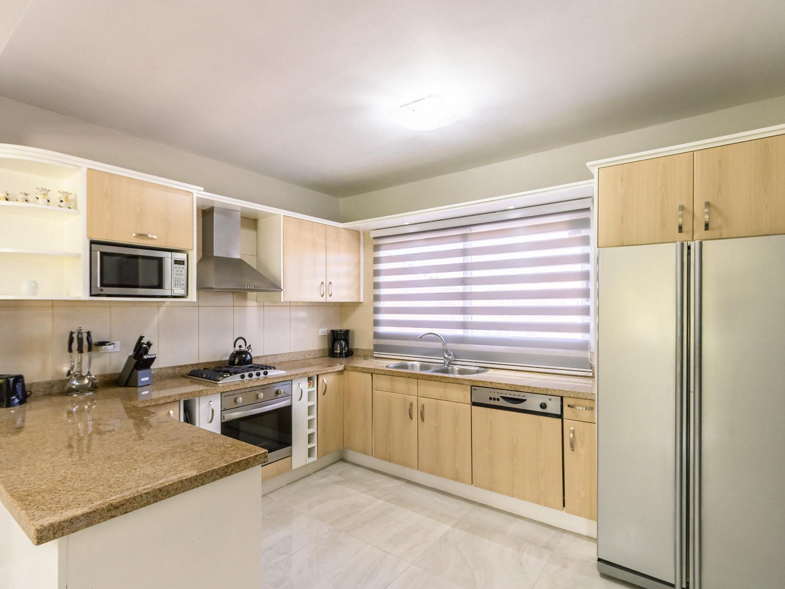 Eclat Kitchen of the 3BR Condo in Oranjestad Aruba - Fully equipped kitchen - Functional and aesthetically pleasing storage solutions - Open concept connecting the kitchen to the Dining and Living Area