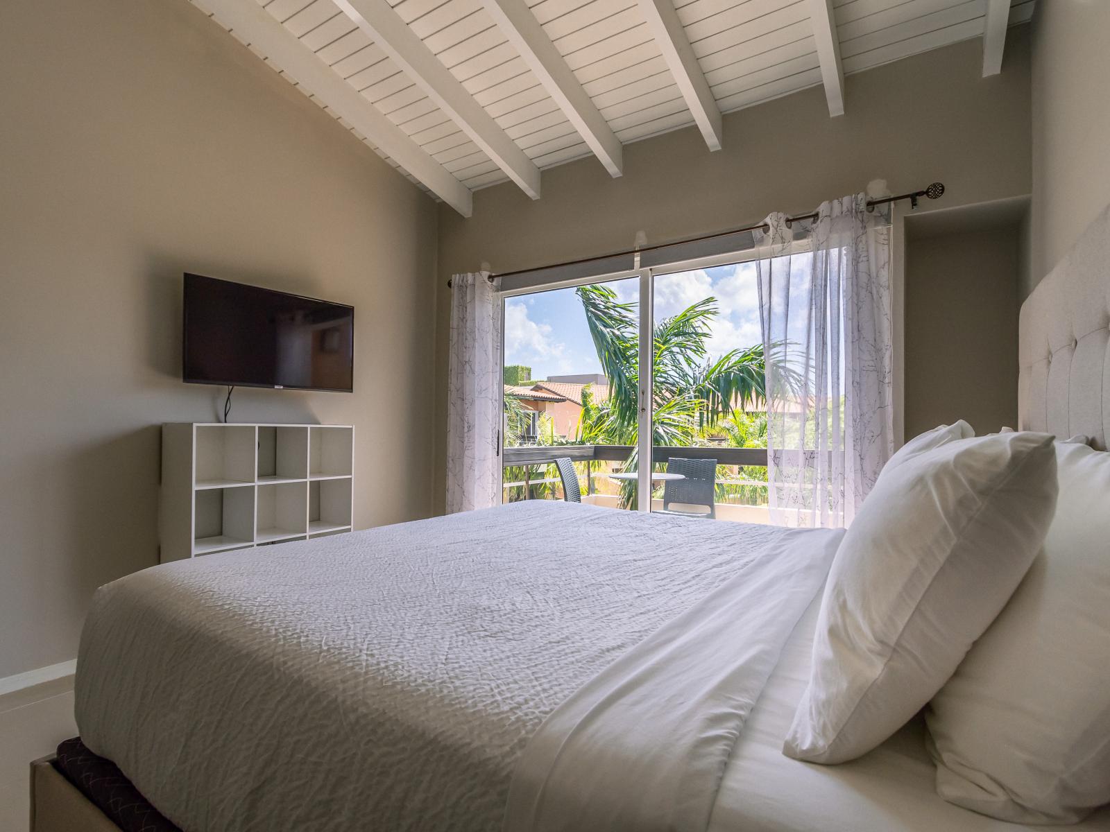 Relax in the main bedroom, complete with a king-size bed, a sofa bed, and an en-suite bathroom.