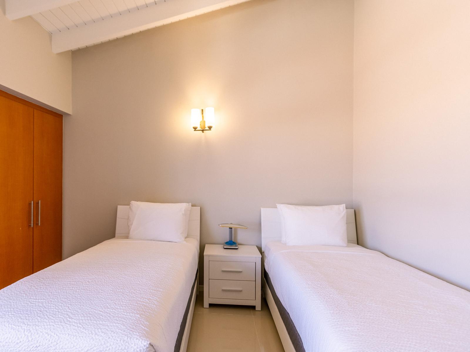 Bedroom 2 features two twin-size beds and a sleeper sofa for versatile sleeping arrangements.