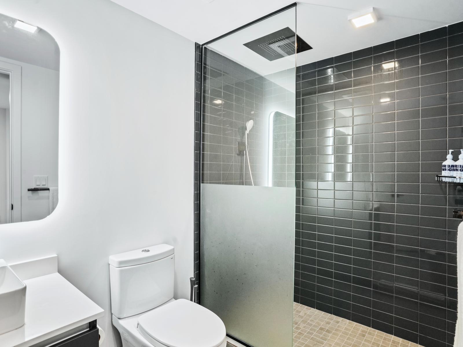 Full bath w/ walk-in shower - Modern and spotless bathroom is luxuriously spacious and features a glass shower stall and modern fixtures.