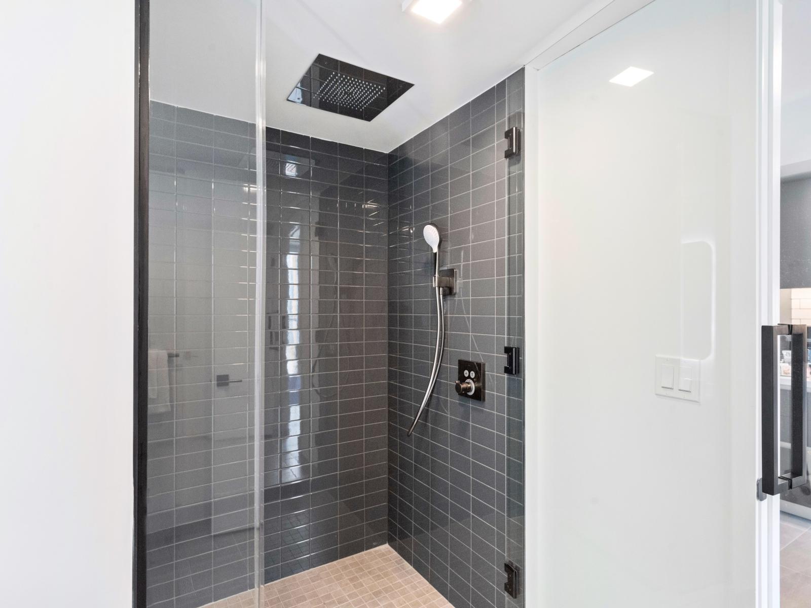 Walk into Relaxation: Our Airbnb bathroom invites you to indulge in a modern retreat, complete with a spacious walk-in shower for a luxurious bathing experience