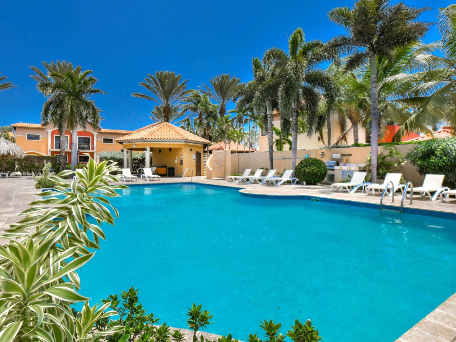 Shared pool with lounge chairs to soak up the sun