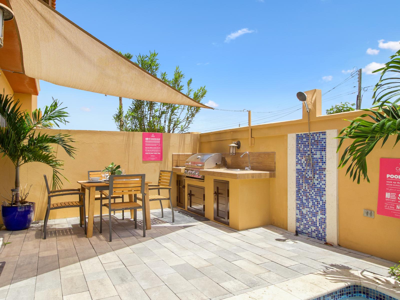 Cozy outdoor seating area by the pool with an outdoor shower