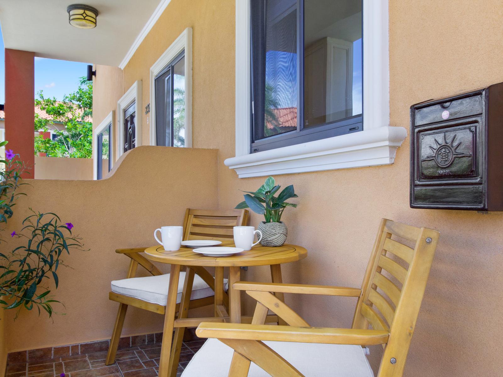 Unwind in the charming front porch seating area, a perfect spot for enjoying a morning coffee or evening relaxation.