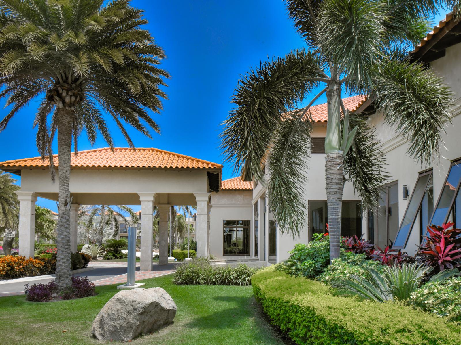 Step into the serene lobby area, beautifully surrounded by lush greenery for a refreshing and welcoming atmosphere.