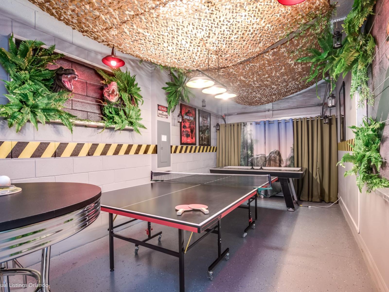 Jurassic-themed game room of the villa in Kissimmee Florida - An action-packed tennis table for friendly competitions - A stylish air hockey table for leisurely games or intense matches