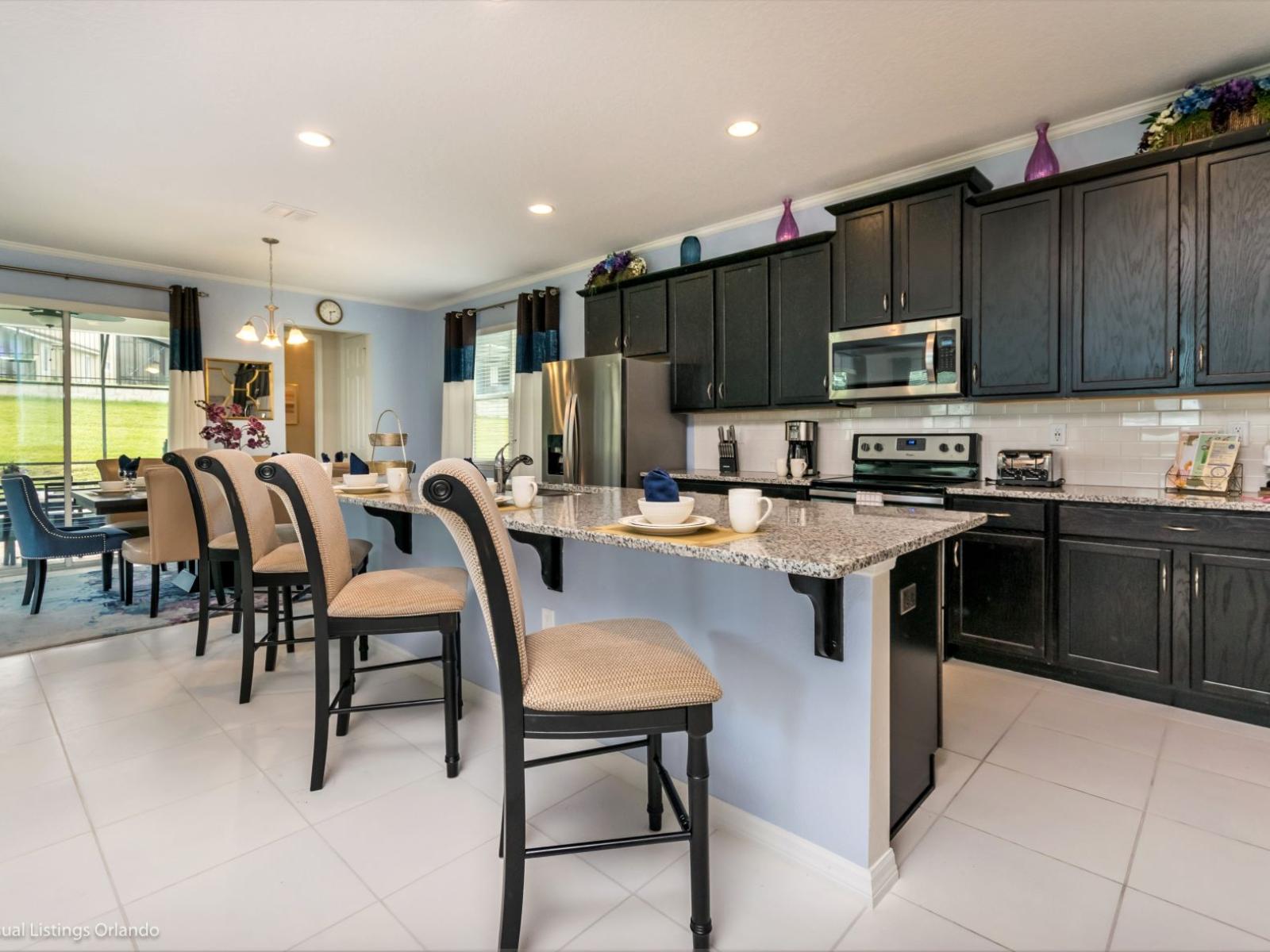 Chic kitchen of the villa in Kissimmee Florida - Modern kitchen with sleek, stainless-steel appliances - Smart use of space with versatile storage solutions - Fully Equipped - High chairs and breakfast bar