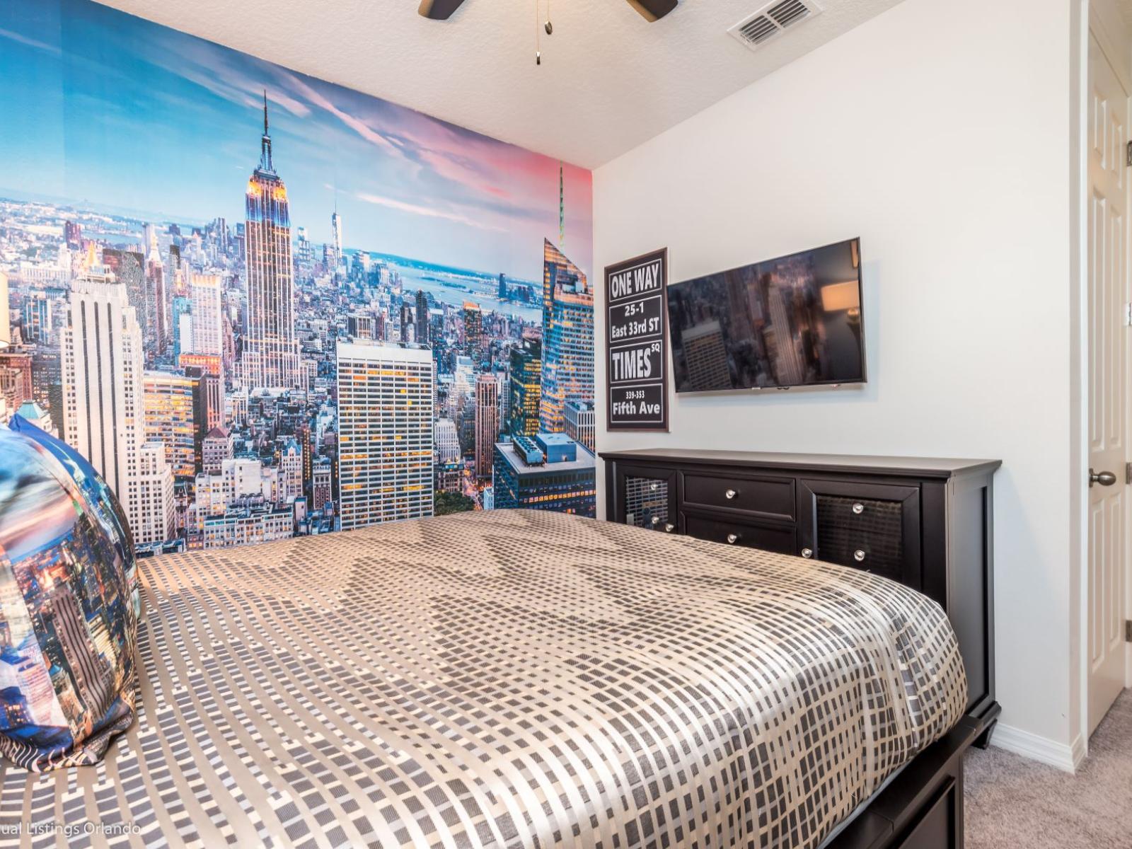 The bedroom with a city accent wall brings the urban landscape indoors. The skyline mural or artwork captures the bustling energy of city life, creating a focal point that inspires imagination and exploration