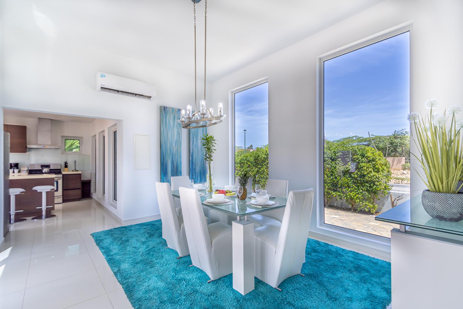 Sophisticated Dining Area of the 3BR house in Noord Aruba - 6 Persons Dining - Large windows with panoramic Views - Artfully arranged table settings for a touch of elegance.