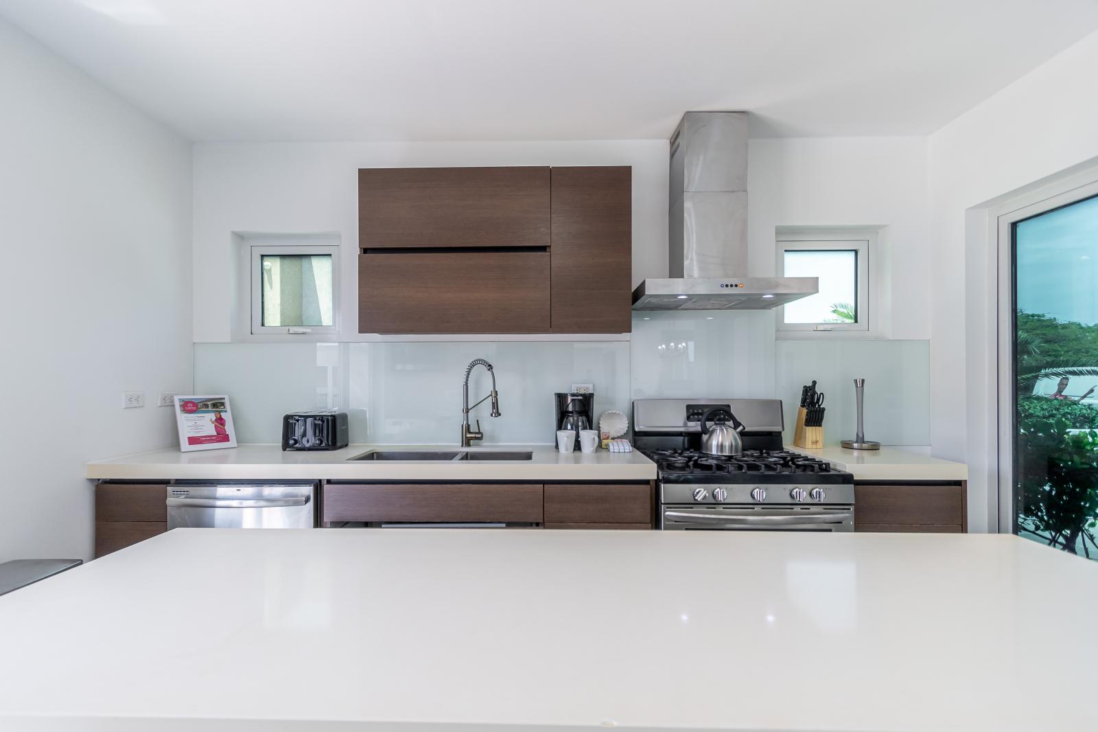 Start Your Day Right: Our Kitchen Features a Stylish Breakfast Bar, Providing the Perfect Spot to Enjoy Morning Coffee or Quick Meals in Comfort and Style