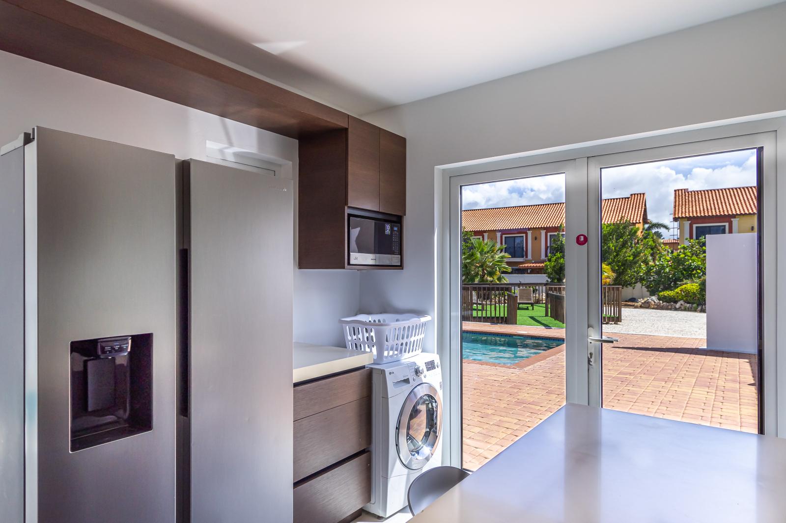 Lush kitchen area of the 3BR house in Noord Aruba - Access to pool area - Integrated appliances for a seamless and stylish appearance - Thoughtful placement of essentials for easy access